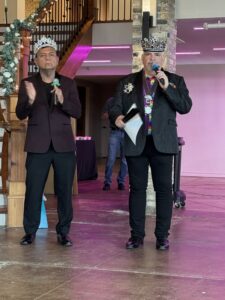 Emperors Raymond and Fidel speak into microphones at the Pride Gala 2025.