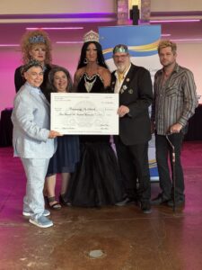 Members of the Royal Sovereign Imperial Court present a large donation check to Communities In Schools.